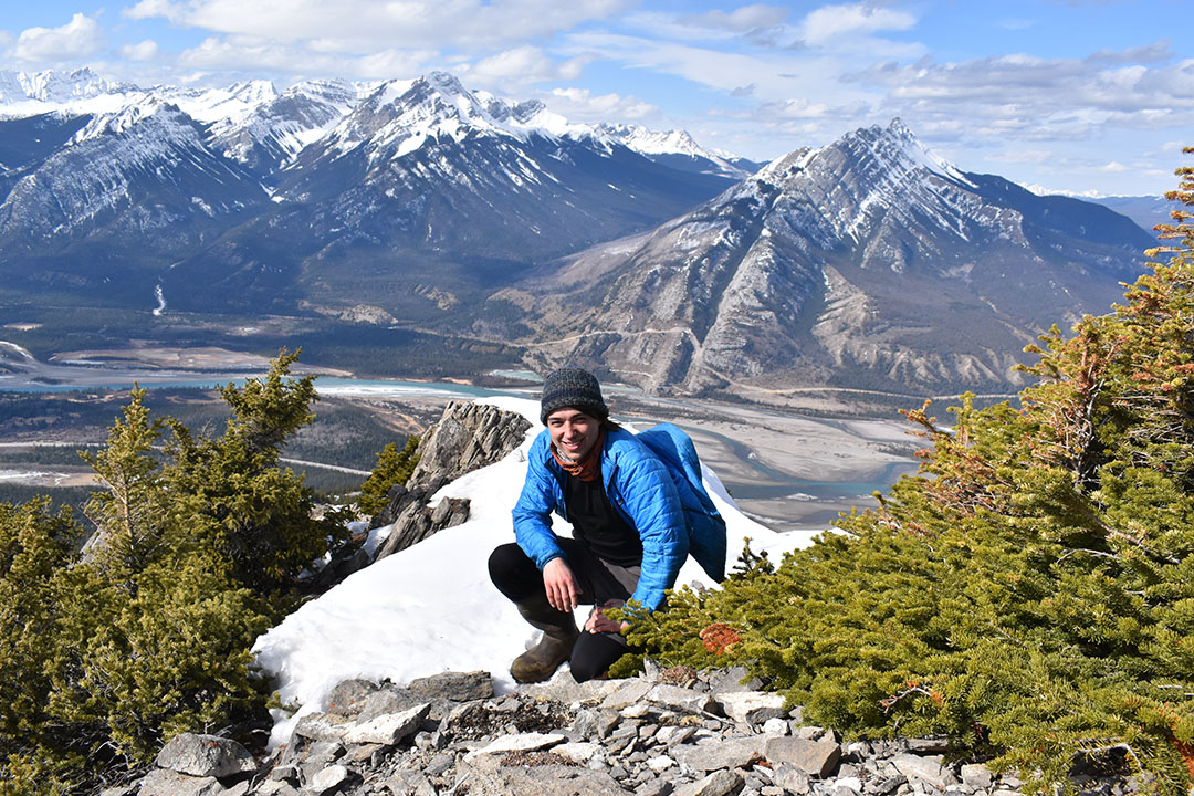 student Jordan Shirley is seen here hiking in Jasper, Alberta, with the Rocky Mountains seen in the background. 