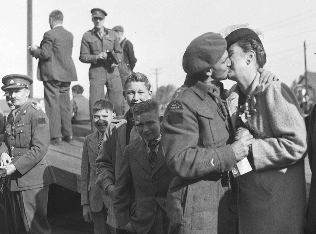 Lt. Col. Drayton Walker is welcomed home by his wife Margaret and their three sons, Phil, Teddy and Peter (in back, first child from the left), on the return of the Saskatoon Light Infantry to the city on Oct. 3, 1945. (Photo: Saskatoon Public Library - Local History Room)