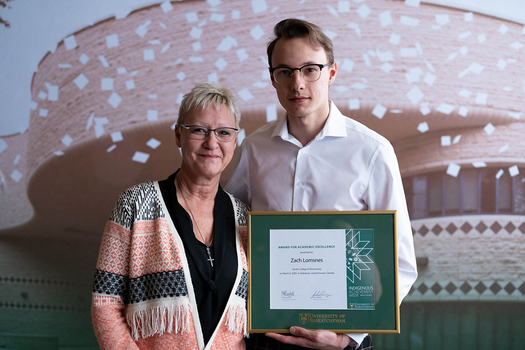 Zach Lomsnes receives his 2024 Indigenous Achievement Award. (Photo: Submitted)
