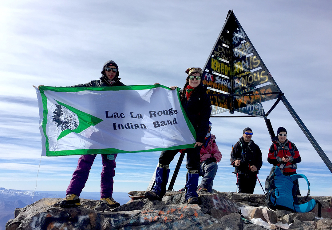 USask’s Jamie LaFleur (centre) climbed Mount Toubkal in Morocco in 2016 and planted her band flag at the summit. (Photo: Submitted)
