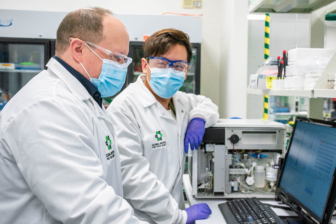 OPAL research technicians Rick Goertzen (left) and Zhijian Chai of GIFS discuss data in the lab. (Photo: David Conlin)