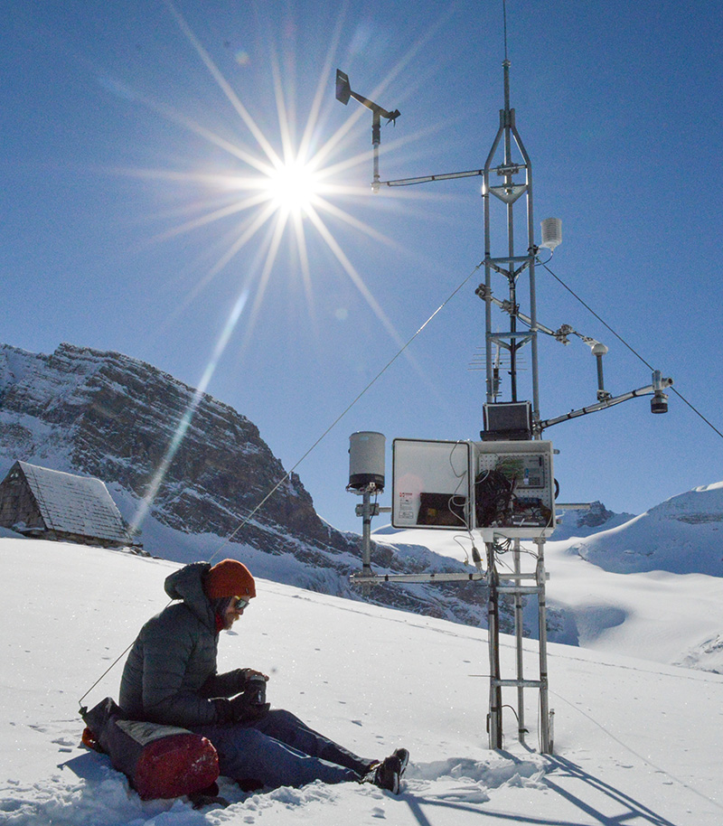 Field research technician Greg Galloway of USask’s Centre for Hydrology refuels while maintaining a weather station at the Peyto Glacier. (Photo: Caroline Aubry-Wake)