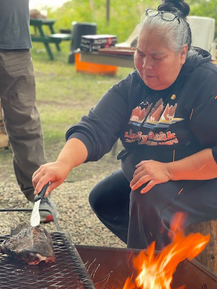 USask Cree scholar Kevin Lewis spreads a mixture of moose brains and Dove soap onto a skin to soften it for use as a moccasin. (Photo: Chelsea Laskowski)