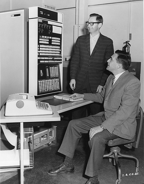 Circa 1966, Bernie Molaro, a long-time employee of the University of Saskatchewan, stands next to an IBM 7040, the third computer purchased by the university back in 1965. (Photo: University Archives A-1873) 