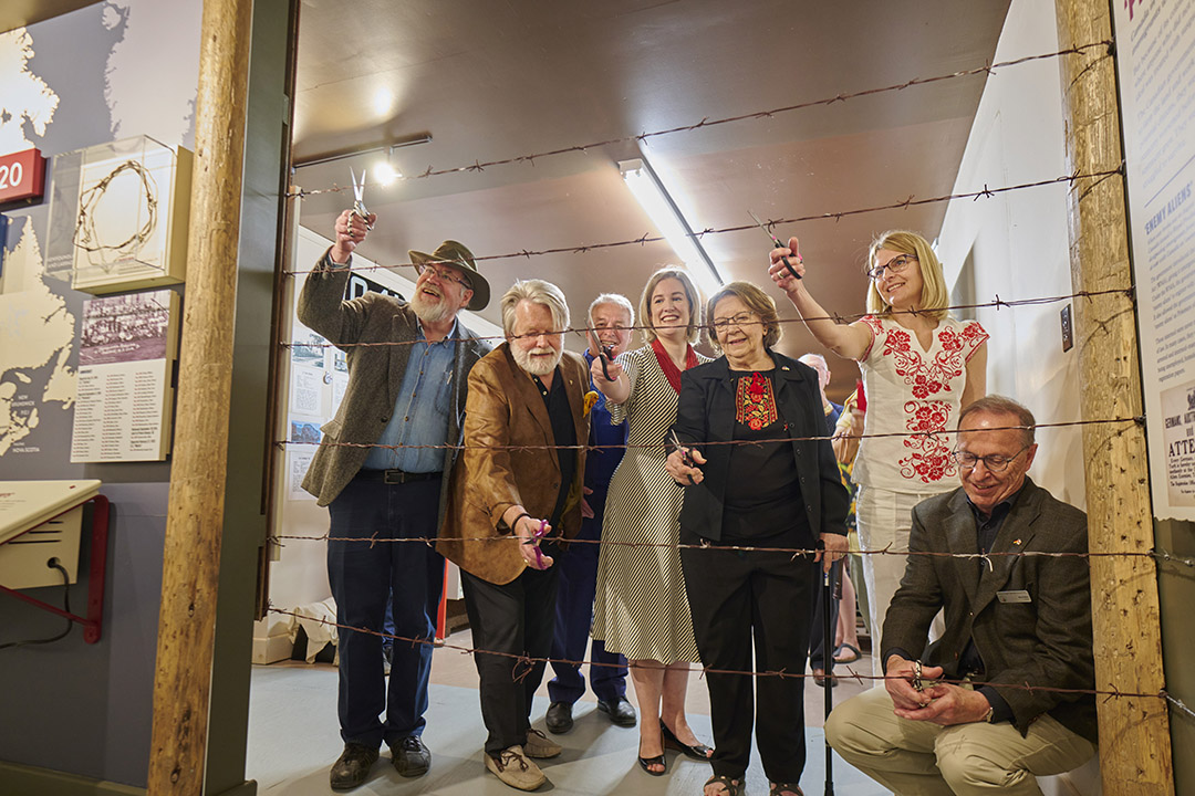 The Eaton Internment Camp Permanent Exhibit officially opened June 4. From left, Saskatchewan Railway Museum President Cal Sexsmith, USask Professor Emeritus Dr. Bohdan Kordan, STM Prairie Centre for the Study of Ukrainian Heritage Director Dr. Nadya Foty-Oneschuk, Patricia Mialkowsky (daughter of internment camp survivor), Ukrainian Canadian Congress of Saskatchewan President Elena Krueger, Saskatchewan German Council President Mervin Weiss. Behind them: Adrian Boyko, on behalf of the Canadian First World War Internment Recognition Fund. (Photo courtesy of Saskatchewan German Council)