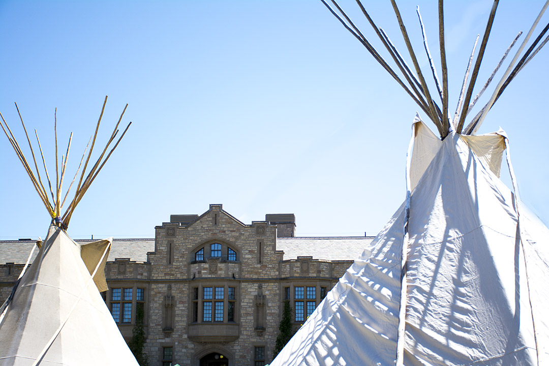 The Usask PMB building with teepees set up in the foreground. 