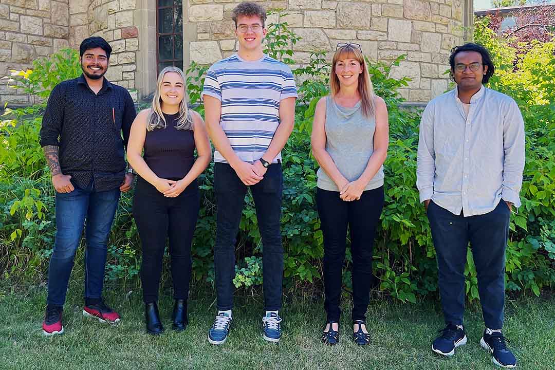 A USask College of Medicine research team including Saurav Rout, Maddie Stewart, Nathan Seidel, Dr. Kerry Lavender, and Satyajit Biswas poses on campus in a group photo.