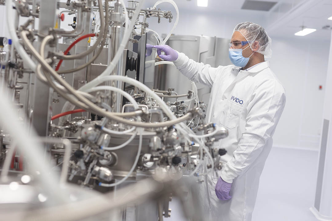 Employee in protective clothing works in VIDO's new Vaccine Development Centre