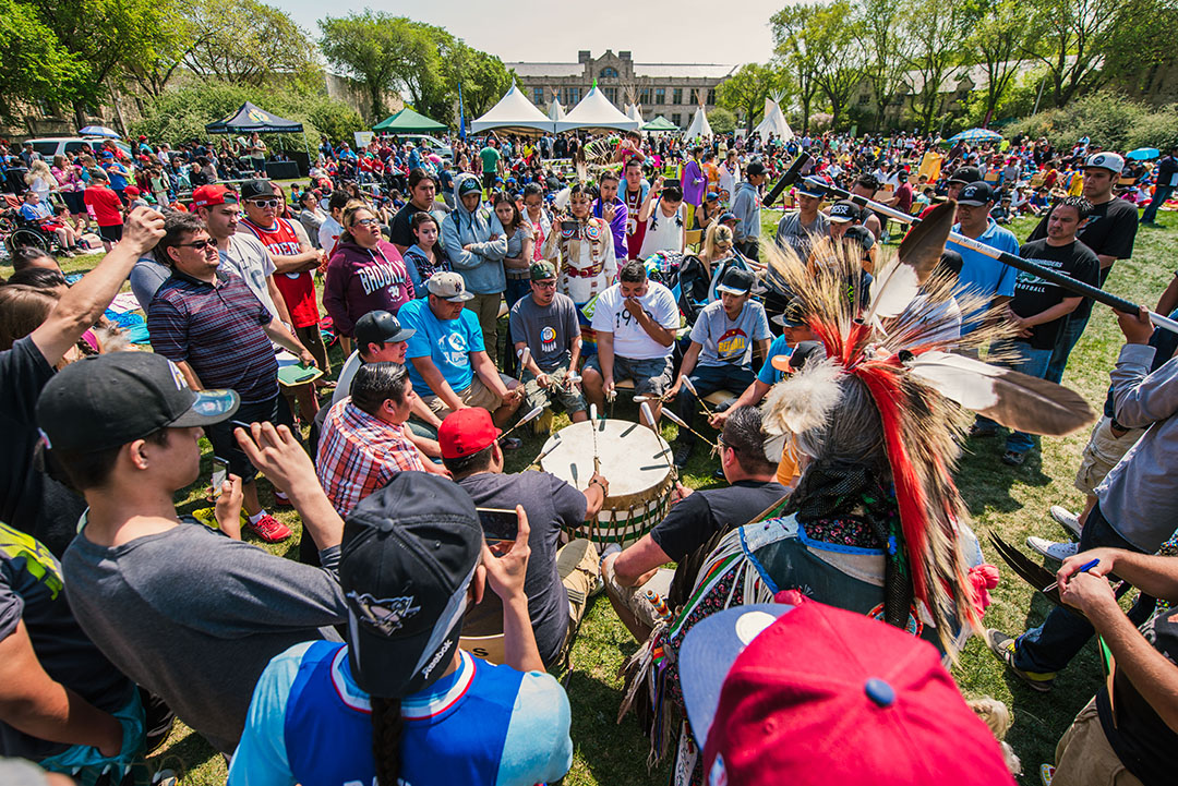 Supporters and participants gather around a drum circle during the 2015 Graduation Powwow in The Bowl at USask. (Photo: David Stobbe)