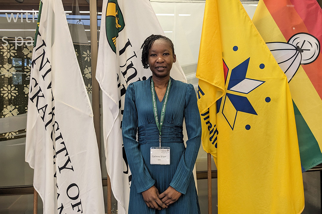 JSGS graduate Carlene Shaw at USask Fall Convocation at Merlis Belsher Place on Wednesday, Nov. 8. Several USask flags can be seen in the background