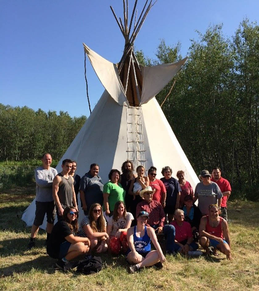 Students and faculty pose for a photo at the land-based culture camp, Poundmaker First Nation in summer 2018. (Photo: Submitted)