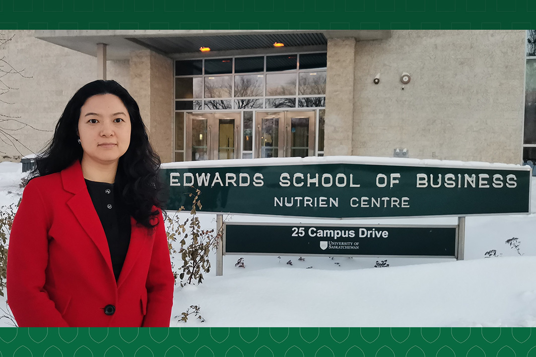 Joan Lu stands outside of the Edwards School of Business at the University of Saskatchewan campus