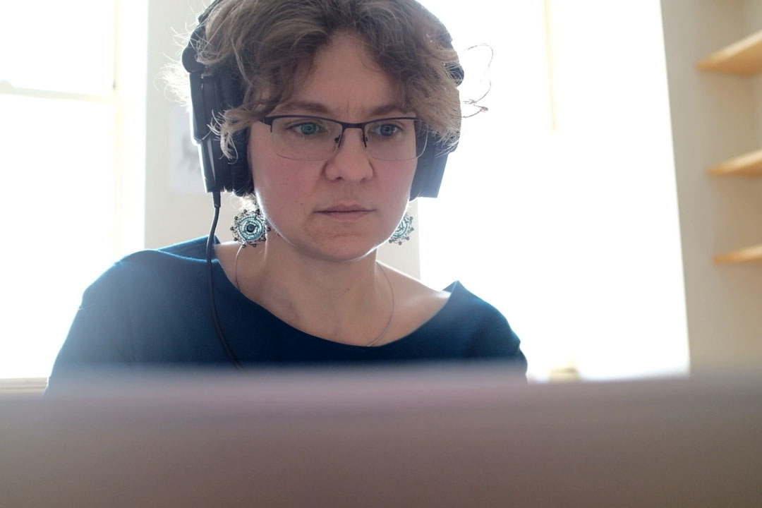 Olga Lovick listens to recordings of Upper Tanana in her office. (Photo: Allain Esquivel)