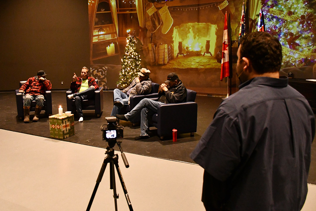 Jarrett Crowe, who works with Pewaseskwan, records the Elders sharing stories and traditional knowledge in Cree at Onion Lake Cree Nation. (Photo by Sarah MacDonald)