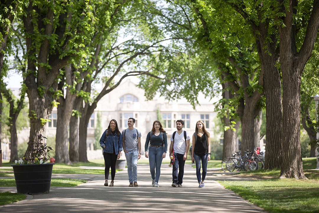 Students walking through the Bowl at the University of Saskatchewan - the Peter McKinnon Building is visible in the background. 