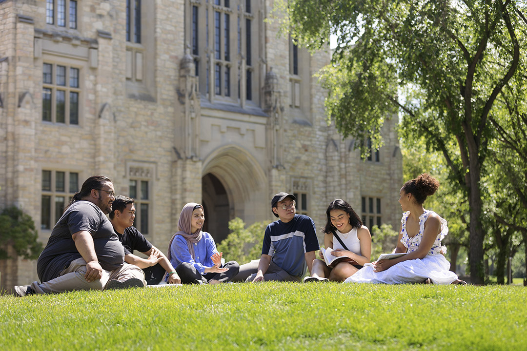 Students walking through the Bowl at the University of Saskatchewan - the Peter McKinnon Building is visible in the background. 