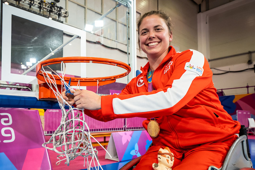 USask graduate and former Huskie women’s basketball player Erica Gavel helps cut down the net after Canada’s gold-medal performance at the 2019 Parapan American Games in Lima, Peru. (Photo: Wheelchair Basketball Canada)