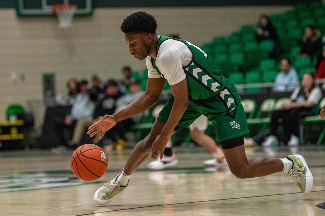 Point guard Fisayo Moibi is playing his fifth and final season with the Huskie men’s basketball team, while also completing his master’s degree this year. (Photo: Electric Umbrella/Huskie Athletics)
