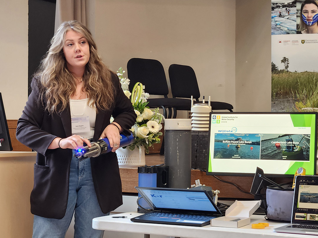 Katy Nugent, a research technician and lab manager for the Global Institute for Water Security, demonstrates water monitoring technology at the Global Water Futures Observatories launch event on April 17, 2024. (Photo: Matt Olson)
