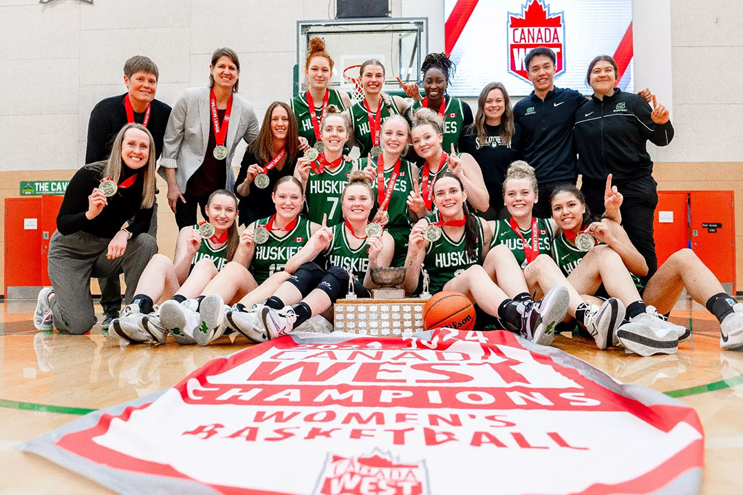 The University of Saskatchewan Huskie women’s basketball team celebrates winning the 2024 Canada West conference championship. (Photo: Matt Johnson Photography)