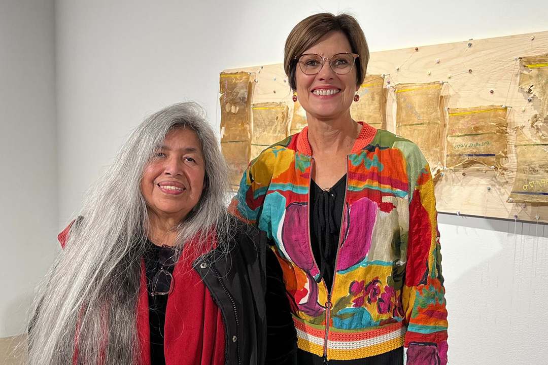 Pictured: Linda Young (left) standing next to supervisor Debbie Pushor (right) at Young's dissertation gallery show