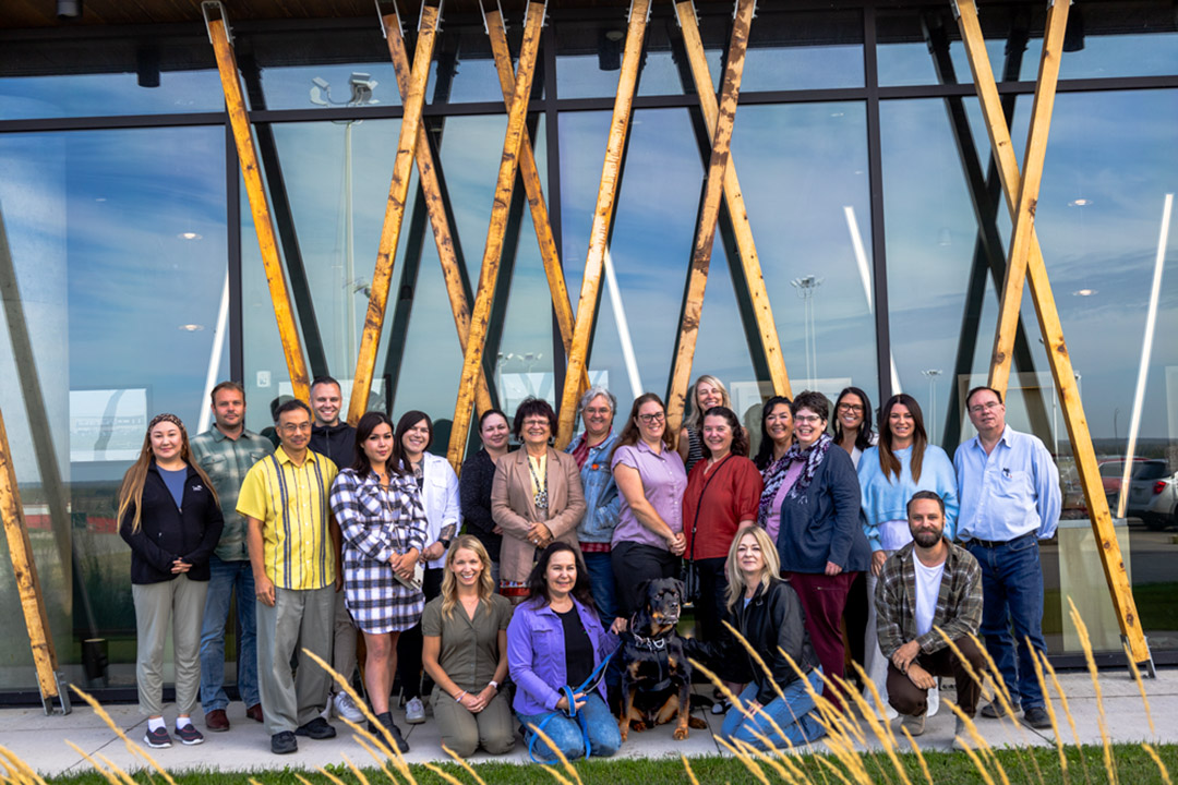 The team with the Saskatchewan Network Environments for Indigenous Health Research (SK-NEIHR) stands for a photo outside of Dakota Dunes during their annual retreat.