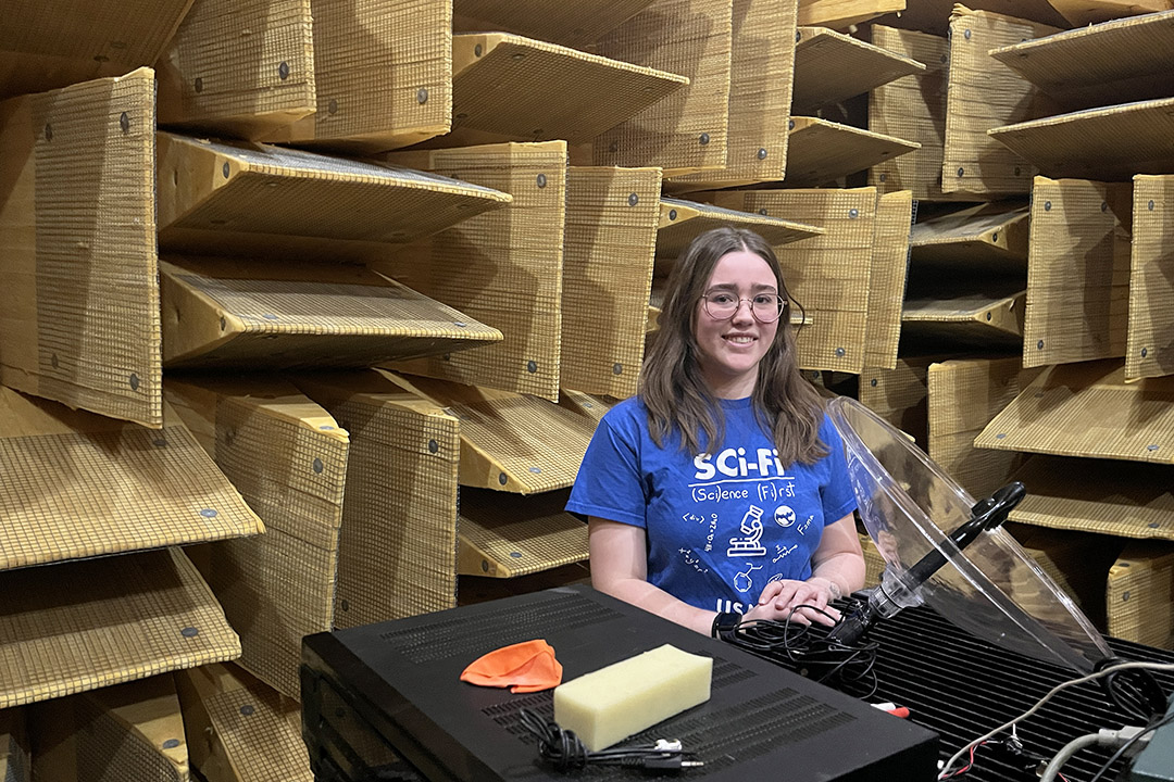 Clara Lightheart, SCI-FI camp instructor and engineering physics student, toured high school students through the anechoic chamber in the College of Engineering. (Photo: Donella Hoffman)