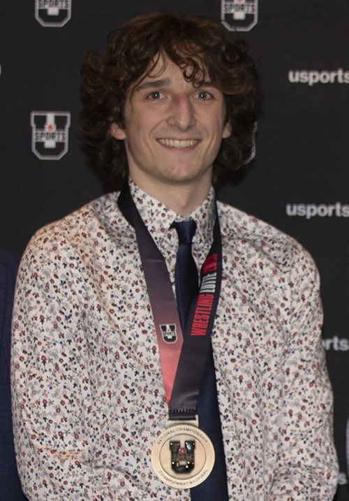 Huskie wrestling student-athlete Drake Buechler is graduating with a Bachelor of Science this week after earning three U Sports Academic All-Canadian Awards and conference and national championship medals. (Photo: Laim Richards/Electric Umbrella)