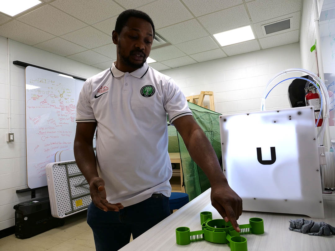 (Left to right, top to bottom) Ines Sanches Rodruguez, Dr. Lori Bradford (PhD), Dr. Renata Mont'Alverne (PhD), Russell Mba, Lindsay Tumback,  Esther Kähne and Akinola Ogbeyemi stand in front of the Engineering Design Mutualism Lab mobile trailer. (Photo by Matt Olson)