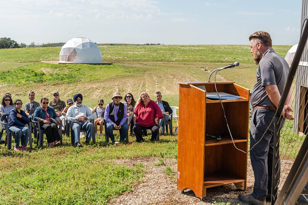 Redberry Lake Biosphere Region (RLBR) executive director Terry Gagne (right) speaks to a crowd of guests and dignitaries gathered for an MOU signing between USask and the RLBR at the grand opening of the new RLBR Interpretive Site and Research Centre. (Photo by Nathan Jones, jonesphoto.ca)